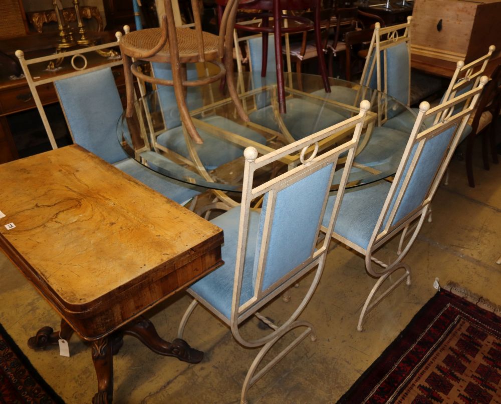 An enamelled metal dining suite comprising a circular glass-topped table and a set of eight chairs, table 138cm diameter